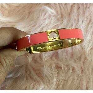 Kate Spade NWT hinged bangle in gold tone with pink enamel and spade cut out
